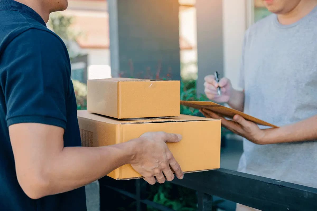 Courier delivering parcels to customer — Infinity Logistics express delivery services