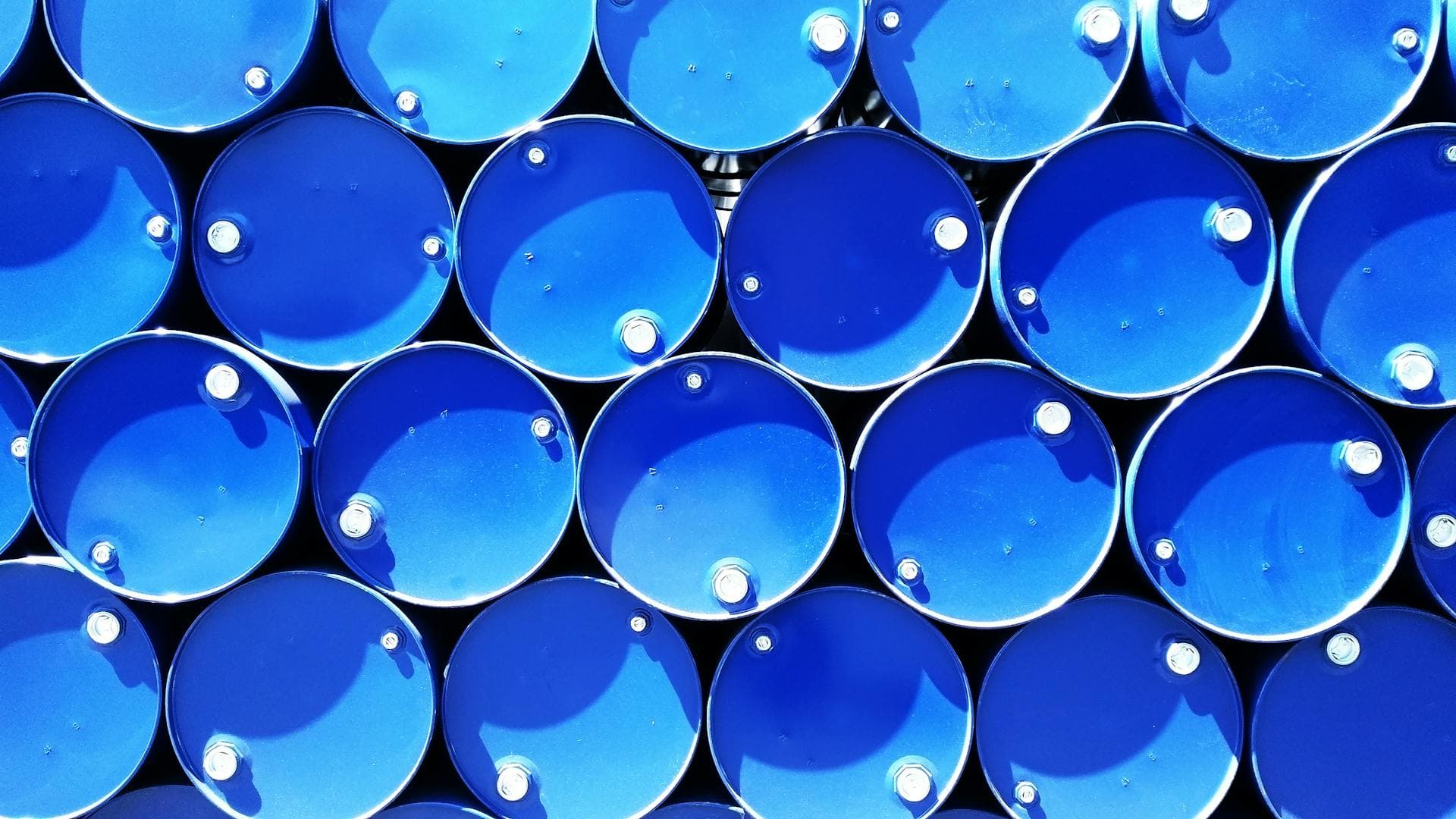 Blue chemical drums viewed from above — Infinity Logistics dangerous goods express
