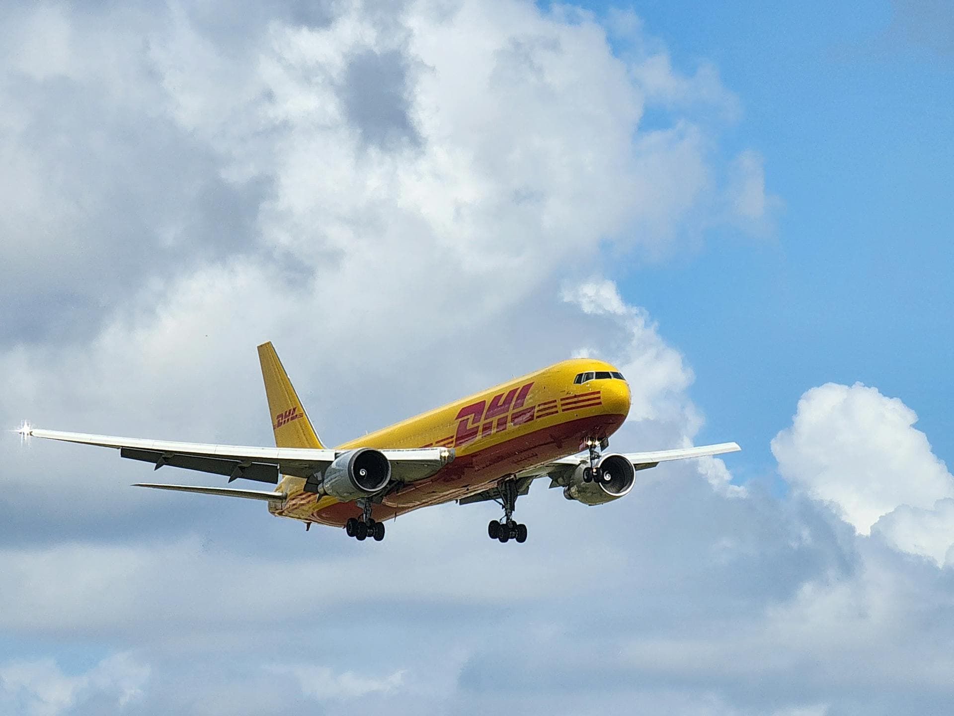 DHL cargo aircraft in flight - Infinity Logistics shipping modes