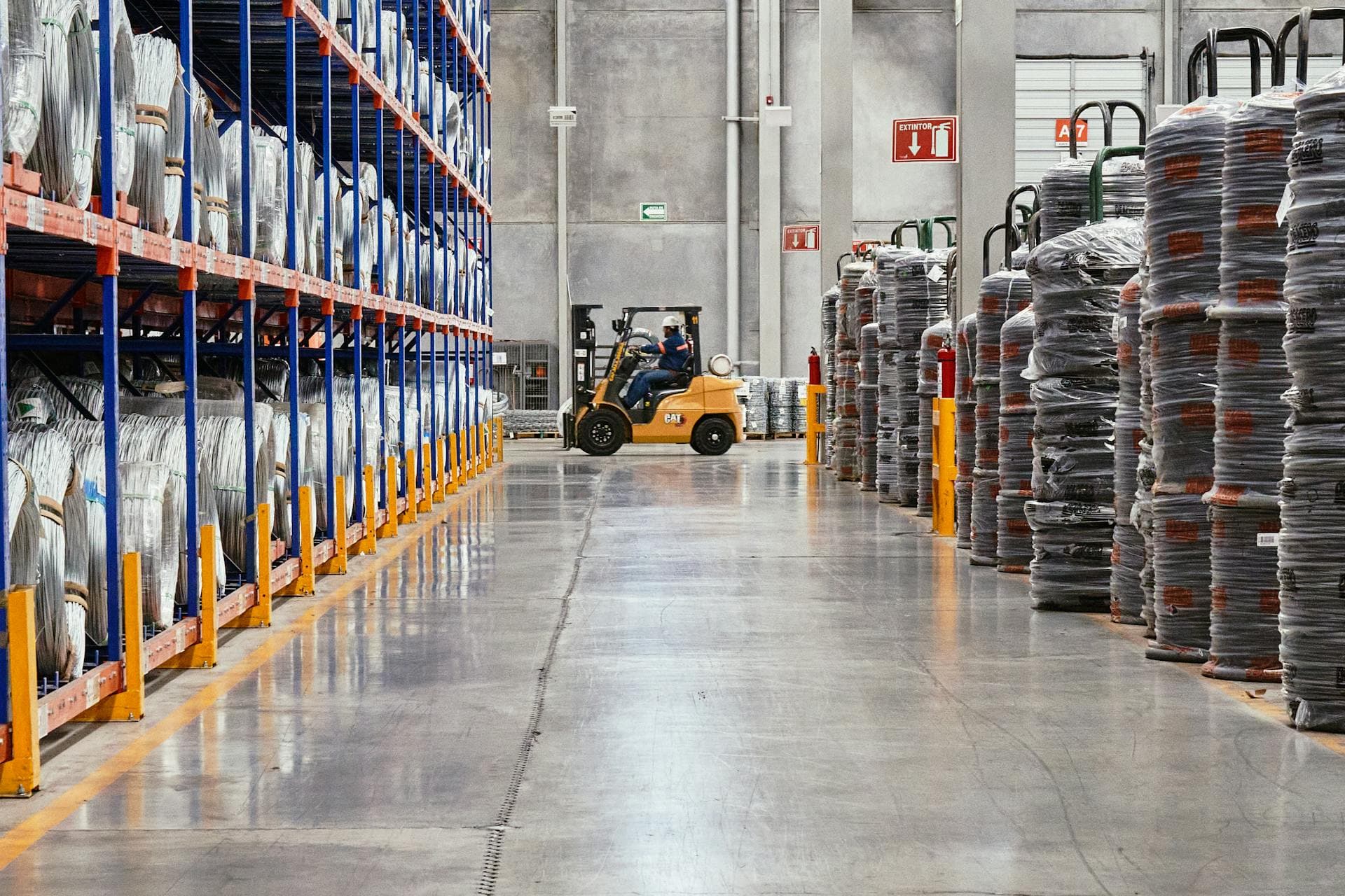 Forklift operating in clean warehouse aisle — Infinity Logistics warehousing
