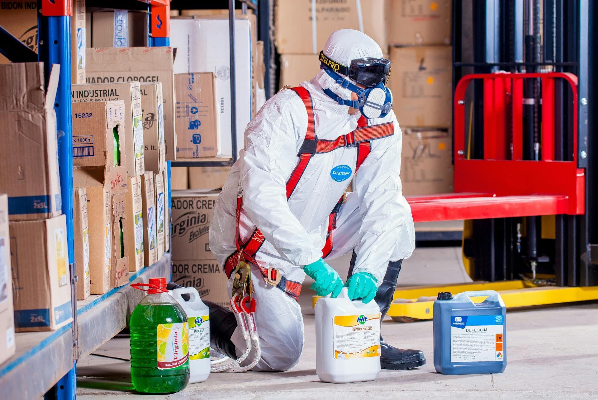 Hazmat worker handling materials in warehouse — Infinity Logistics DG express compliance
