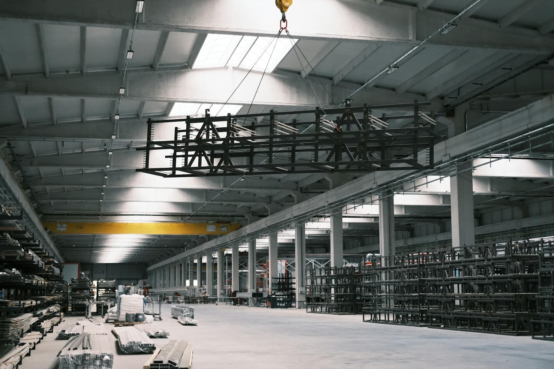 Overhead crane in warehouse handling steel — Infinity Logistics project cargo expertise